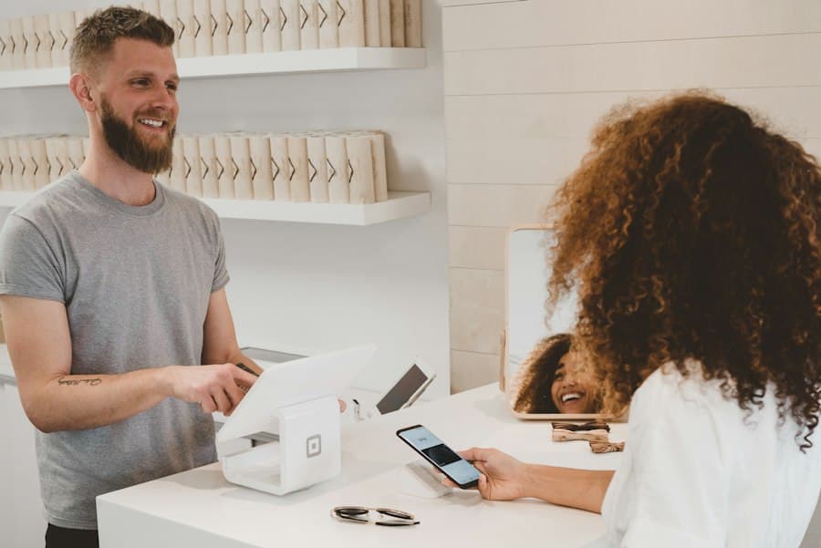Customer paying by phone at a shop counter