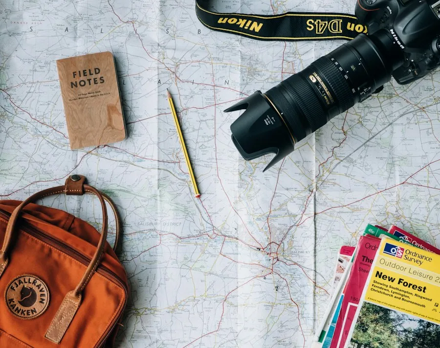 Travel map, camera and guidebooks laid out for trip planning